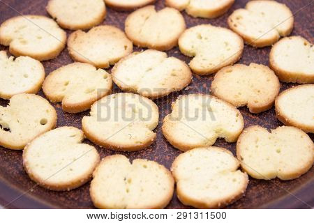 Bake Rolls. The Mini Bread Chips On The Brown Bowl. Isolated On White Background.
