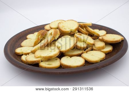 Bake Rolls. The Mini Bread Chips On The Brown Bowl. Isolated On White Background.