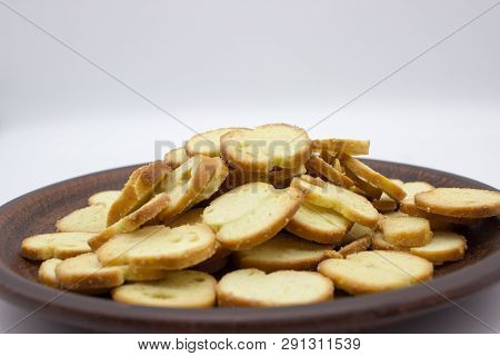 Bake Rolls. The Mini Bread Chips On The Brown Bowl. Isolated On White Background.