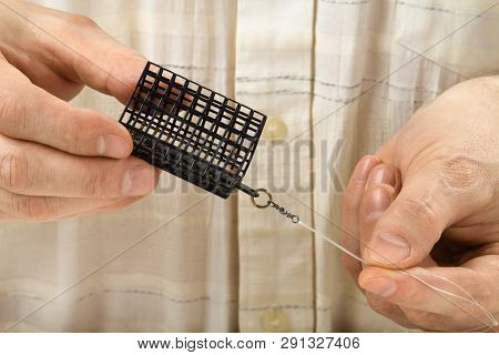 The Cage Feeder Is In Hands Of  Angler, Closeup