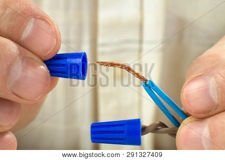 Hands Of An Electrician Connect The Twisted-together Ends Of Wires By Use Twist-on Wire Connector, C