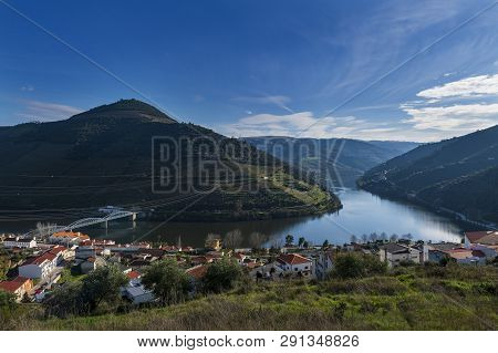 View Of The Pinhao Village With Terraced Vineyards And The Douro River, In Portugal; Concept For Tra