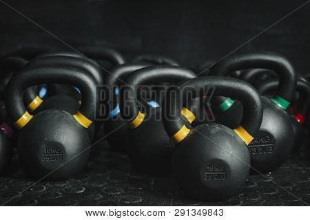 Kettlebells Equipment On Dark Backgroud At The Gym. Sport Concept.