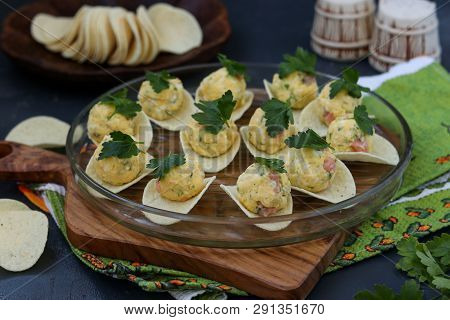 Appetizer On Chips With Salmon, Eggs And Cheese