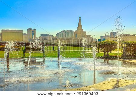 Water Fountain At Souq Waqif Park In Doha Corniche With Doha Spiral Mosque And Minaret On Background