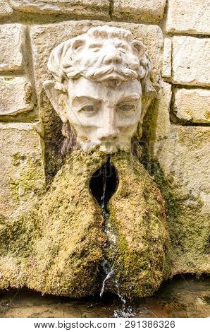 Ancient Stone Fountain. Fountain With Head Of Man.