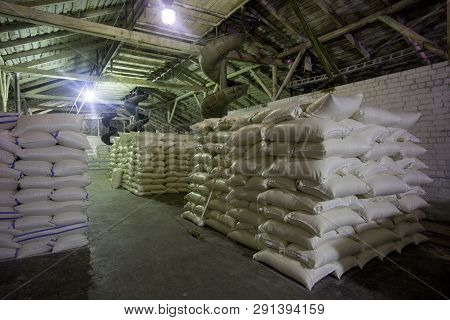 Theme Plant Storage Warehouse. A Lot Of White Fabric Bags With Loose Products Stacked In Piles Indoo
