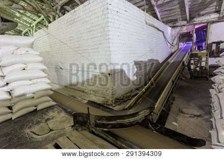 Theme Plant Storage Warehouse. A Lot Of White Fabric Bags With Loose Products Stacked In Piles Indoo