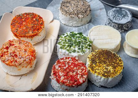 Assortment Of French Fresh White Soft Goat Cheeses With Different Tastes Topping Made With Herbs, Pa