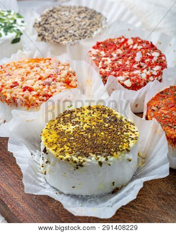Assortment Of French Fresh White Soft Goat Cheeses With Different Tastes Topping Made With Herbs, Pa