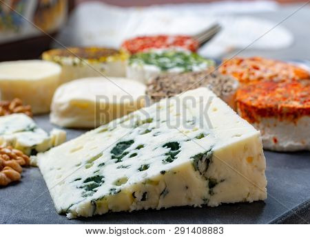 Assortment Of French Fresh White Soft Goat Cheeses With Different Tastes Topping Made With Herbs, Pa