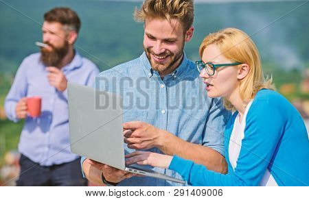 Colleagues Working Laptop, Boss Smoking While Coffee Break On Background. Colleagues With Laptop Wor
