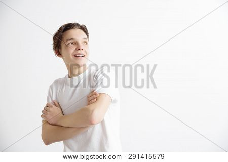 Looking For The Best Moment. Young Dreaming Smiling Teenager Is Waiting For Chanses Isolated On Gray
