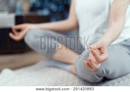 Close Up Of Woman Taking Asana Position. A Woman Over 50 Years Old Doing Yoga At Home.