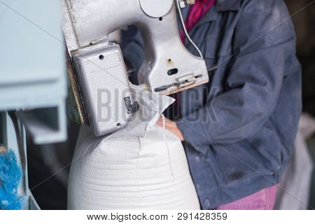 Work On The Production Of Agricultural Products. A Caucasian Woman Dressed In An Iniform Performs Wo