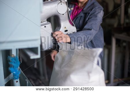 Work On The Production Of Agricultural Products. A Caucasian Woman Dressed In An Iniform Performs Wo