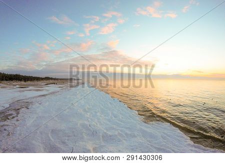Sunset On The Icy Beach With Snow On The Coast Of Baltic Sea, Palanga, Lithuania