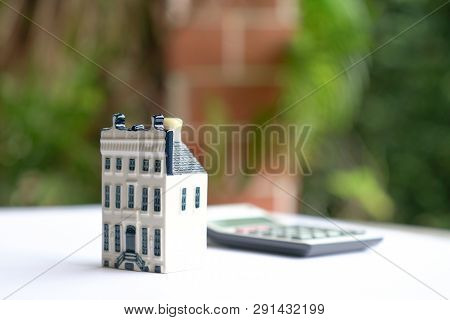 Property House With Calculator, Concept For Real Estate Or Mortgage And House Finance Or Loan
