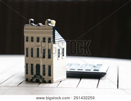 Property House With Calculator, Concept For Real Estate Or Mortgage And House Finance Or Loan