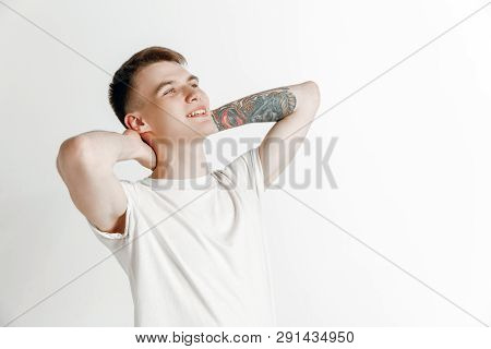 Looking For The Best Moment. Young Dreaming Smiling Teenager Waiting For Chanses Isolated On A Gray 