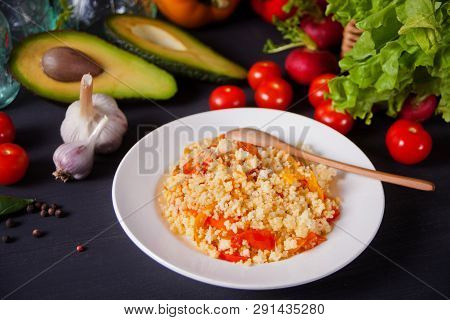 Homemade Vegetarian Couscous With Tomatoes, Carrots, Pepper On A Dark Kitchen Table With Vegetables 