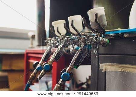Spray Gun On Wood Table. In Auto Service. Used For Industrial Painting And Coating.