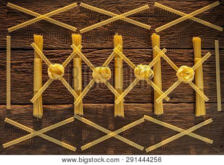 Pasta Placed With Geometric Signs On A Wooden Background