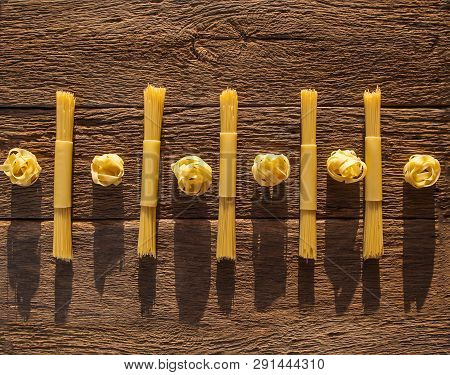 Pasta Placed With Geometric Signs On A Wooden Background