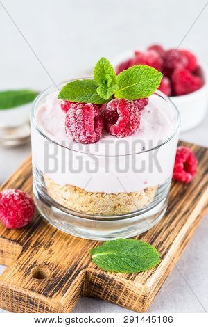 No Baked Cheesecake With Raspberry In Glass Jar. Healthy Dessert.