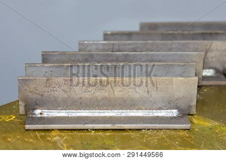 Close Up Welding Seam Type Display Tee Joint Of Steel Metal Plate On Table