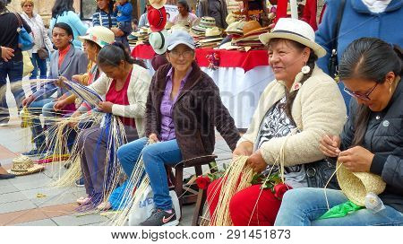 Cuenca, Ecuador - March 8, 2019: Women In Traditional Dresses Of Azuay Province Demonstrate Weaving 