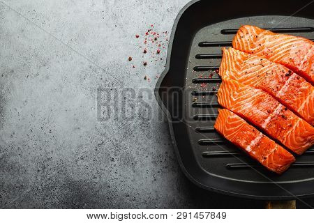 Top View, Close-up Of Cut In Slices Fresh Raw Salmon Fillet With Seasonings On Grill Skillet, Gray S