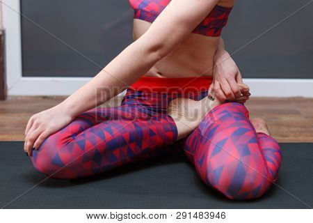 Young Sporty Woman Practicing Yoga, Doing Mahamudra Stretching Position In A Fitnes Club