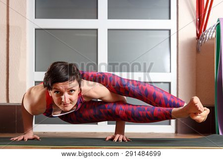 Young Sporty Woman Practicing Yoga, Doing Mahamudra Stretching Position In A Fitnes Club