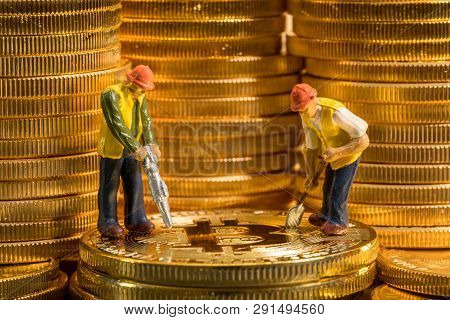 Concept Illustration Of Two Miners Mining New Bit-coin Cybercurrency Virtual Coins In The Blockchain