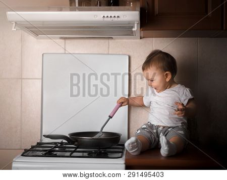 Baby Toodler Preparing Dinner At The Kitchen In The Frying Pan Dark Rich Warm