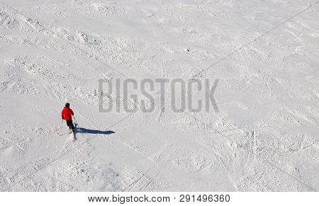 Skier In The Slope In The White Snow In Mountain