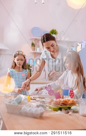 Kind Longhaired Girls Helping Their Mother With Baking