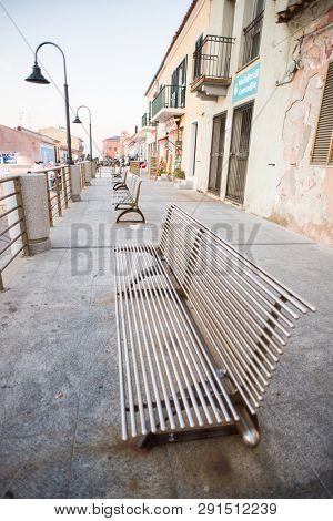 Santa Teresa Gallura, Sardinia, Italy - July 8, 2018: Benches on Square of Town Santa Teresa di Gallura in Sardinia, Italy.