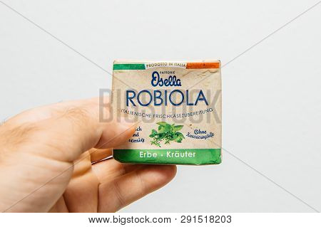 Paris, France - Jul 6, 2018: Man Hand Holding Against White Background New Fresh Package Of Robiola 