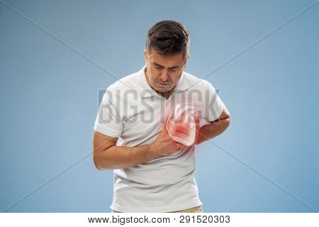 people, healthcare and health problem concept - unhappy middle-aged man having heart attack or heartache over blue background