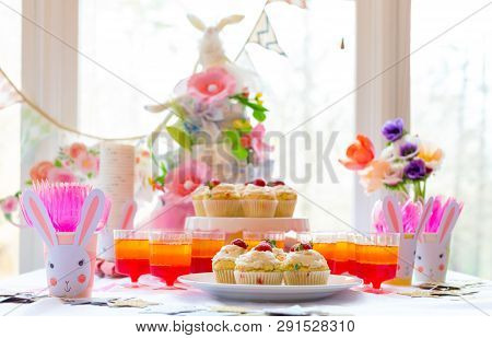 Dessert Table With Cupcakes And Flowers Easter Party Theme
