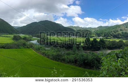 Beautiful View Of The Typical Japanese Countryside With Mountains And Rice Paddies. This Is Located 