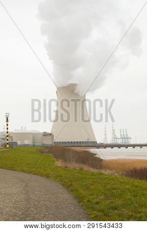 May 2016, Doel, Antwerp, Belgium, Cooling Towers Of The Nucleair Power Plant In Doel Next To The Riv