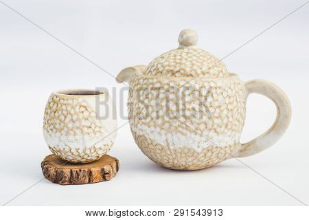 Beige Teapot And Ceramic Stoneware Cup With White Background