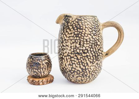 Pitcher And Ceramic Stoneware Tumbler With White Background
