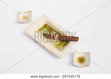 Three Ceramic Stoneware Wells And A Wooden Knife With White Background