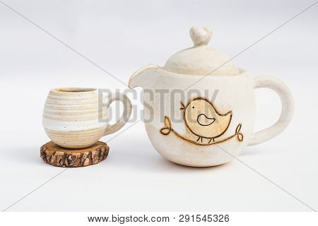 White Teapot And Ceramic Stoneware Cup With White Background