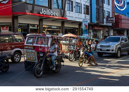 Dumaguete, The Philippines - 10 Mar 2019: Motorbike On Asian City Street. Filipino Tricycle And Bike