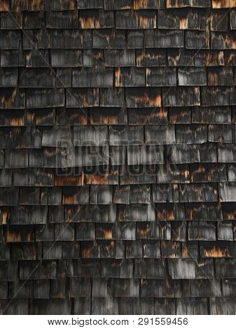 Wooden shingle facade on Austrian house in mountains.